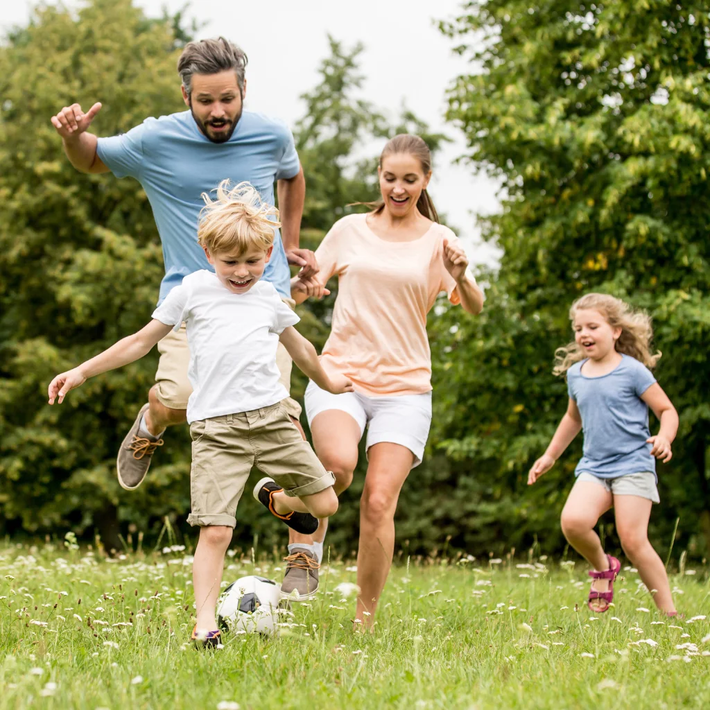 A family playing soccer together in a field